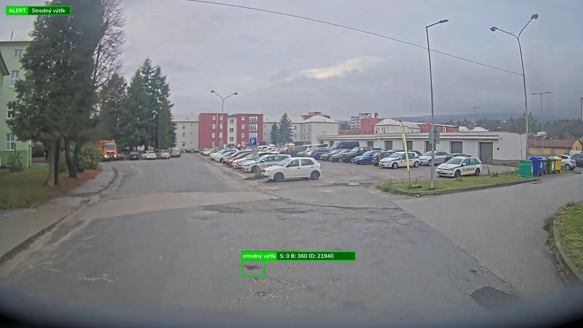 The way into a car park seen from a collection vehicle’s camera, with the console’s alert on a medium pothole